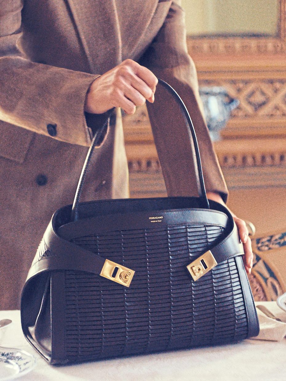 Instantly recognisable, the Hug Bag is given a unique twist with a dense weave of leather straps, accented by gold-tone buckles. Photo: Ferragamo