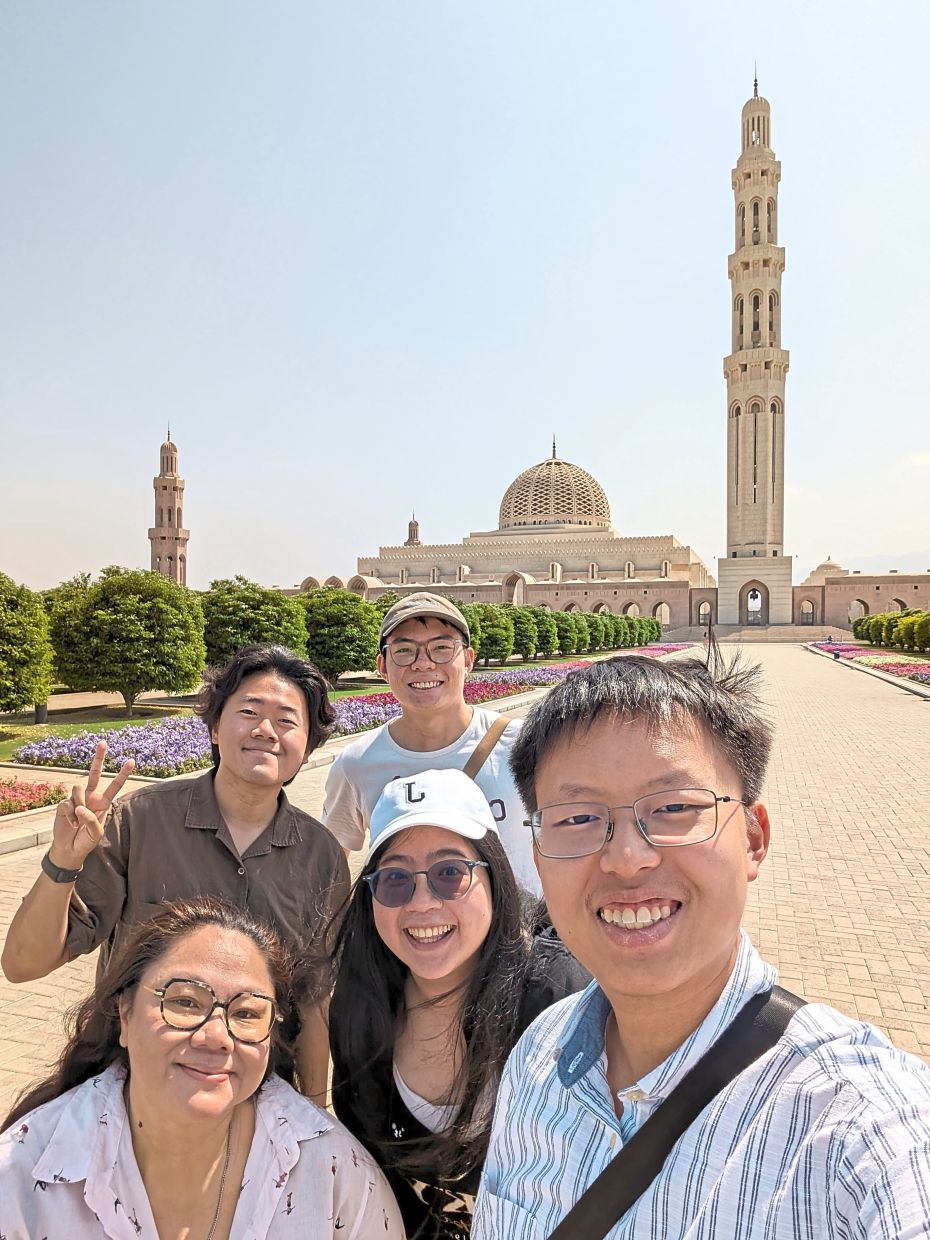 The writer (bottom left) and her new friends (clockwise from right) Hoh Shan, Janice, Hong and Stephen at the grounds of the Sultan Qaboos Grand Mosque in Muscat. — POH HOH SHAN