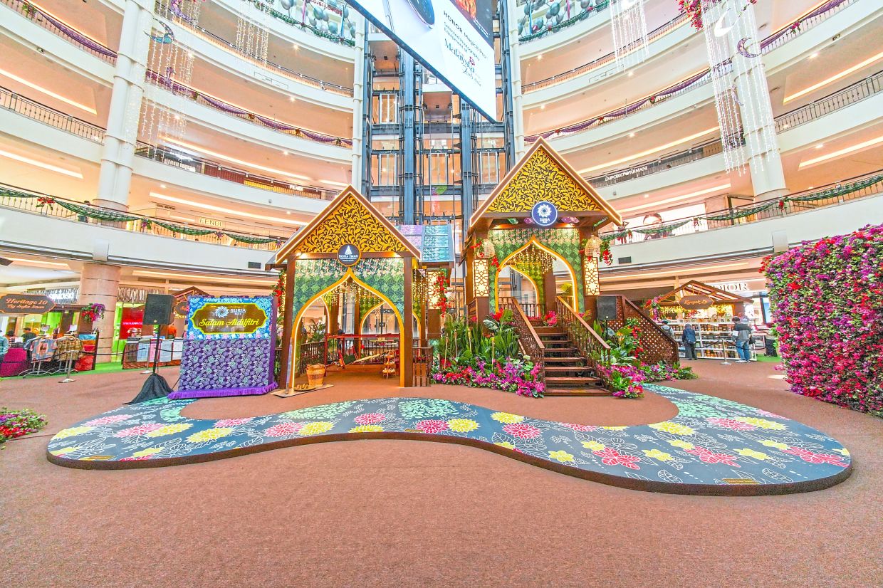 Traditional gazebos adorned with bougainvillea and hand-stamped batik fabric at Suria KLCC.