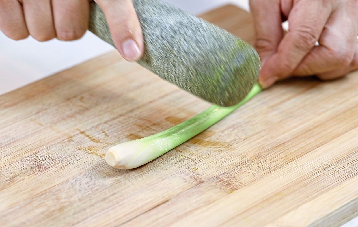 In the rendered fat from the chicken, saute the lemongrass and whole chillies until fragrant.