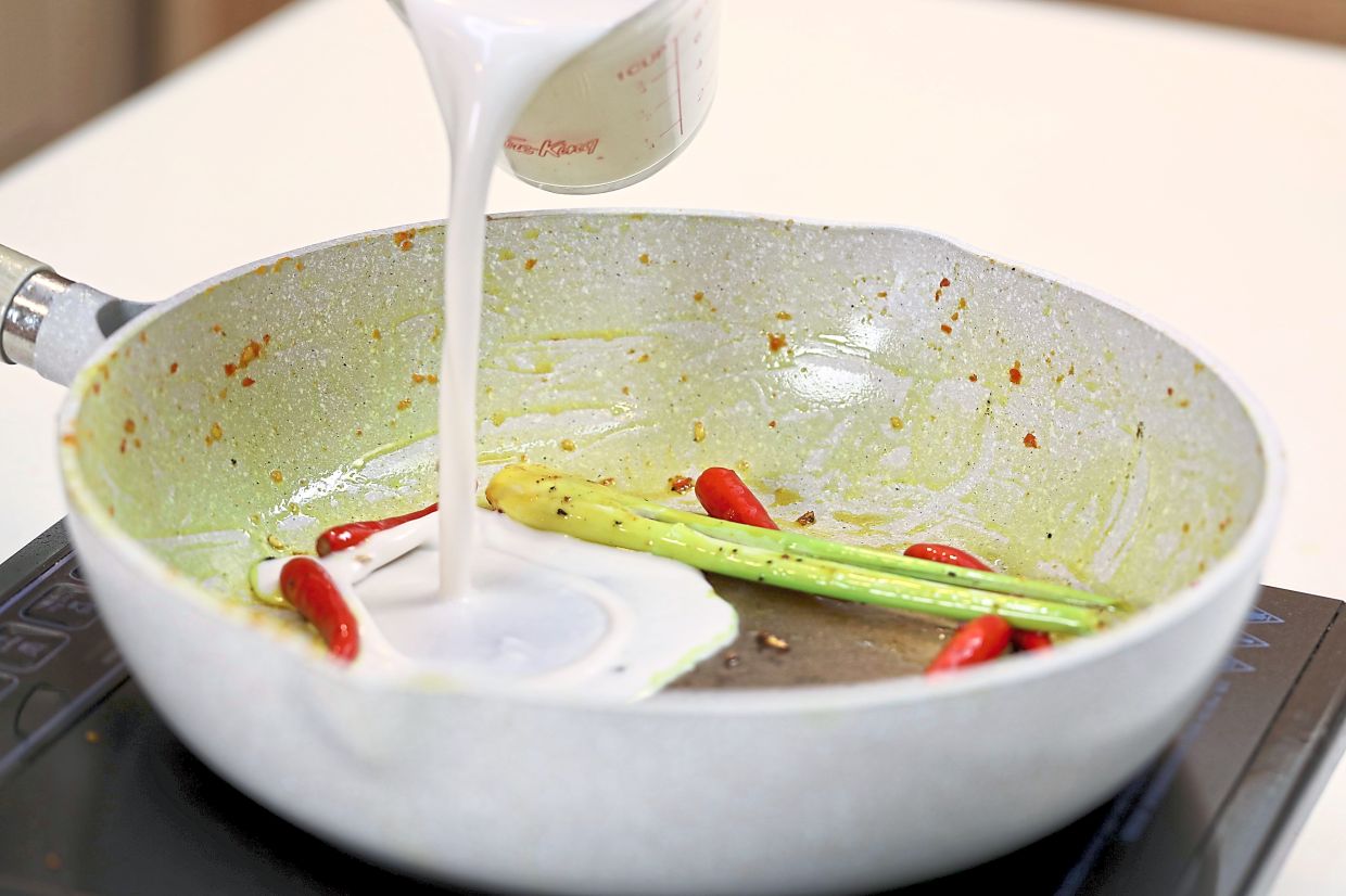 Saute lemongrass, chillies in the rendered chicken fat, then add coconut milk and bring to a light simmer.