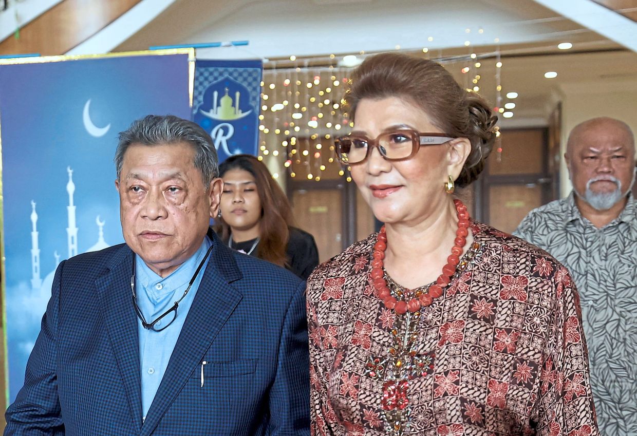 Struck out: Pandikar seen leaving the Kota Kinabalu Court with his wife Puan Sri Diana Diego. — Bernama