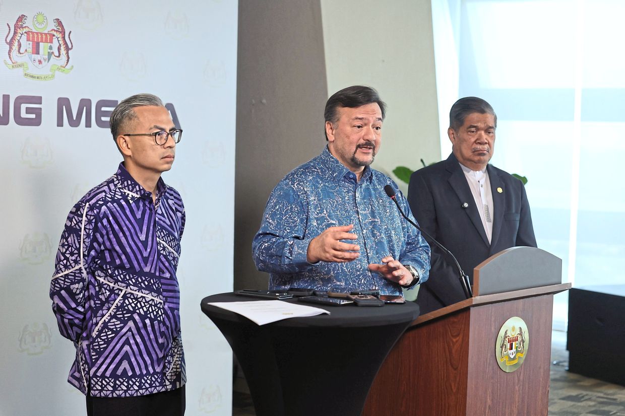 Sharing updates: Amir Hamzah (centre) speaking during a press conference in Putrajaya. With him are Fahmi (left) and Mohamad. — Bernama