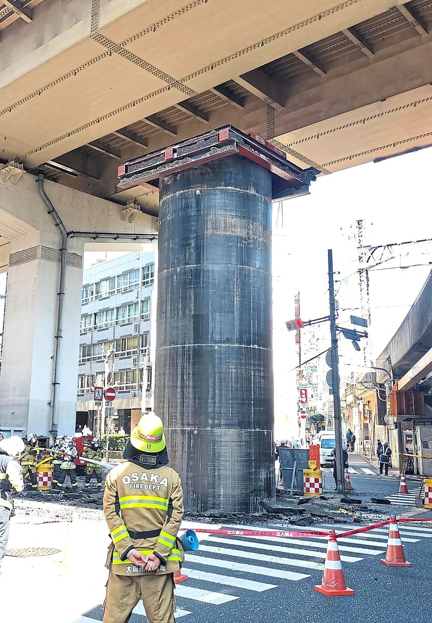 How did it happen?: The steel pipe, protruding more than 10m above ground level, is causing traffic disruptions to motorists and a headache to authorities in Osaka. — AFP