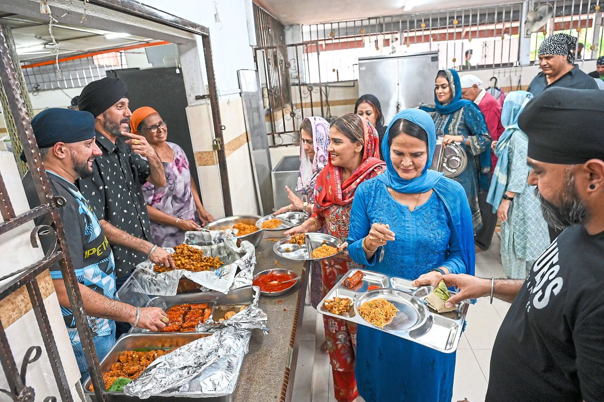 Vegetarian meals from the community kitchen being served at the gurdwara for the last time. 