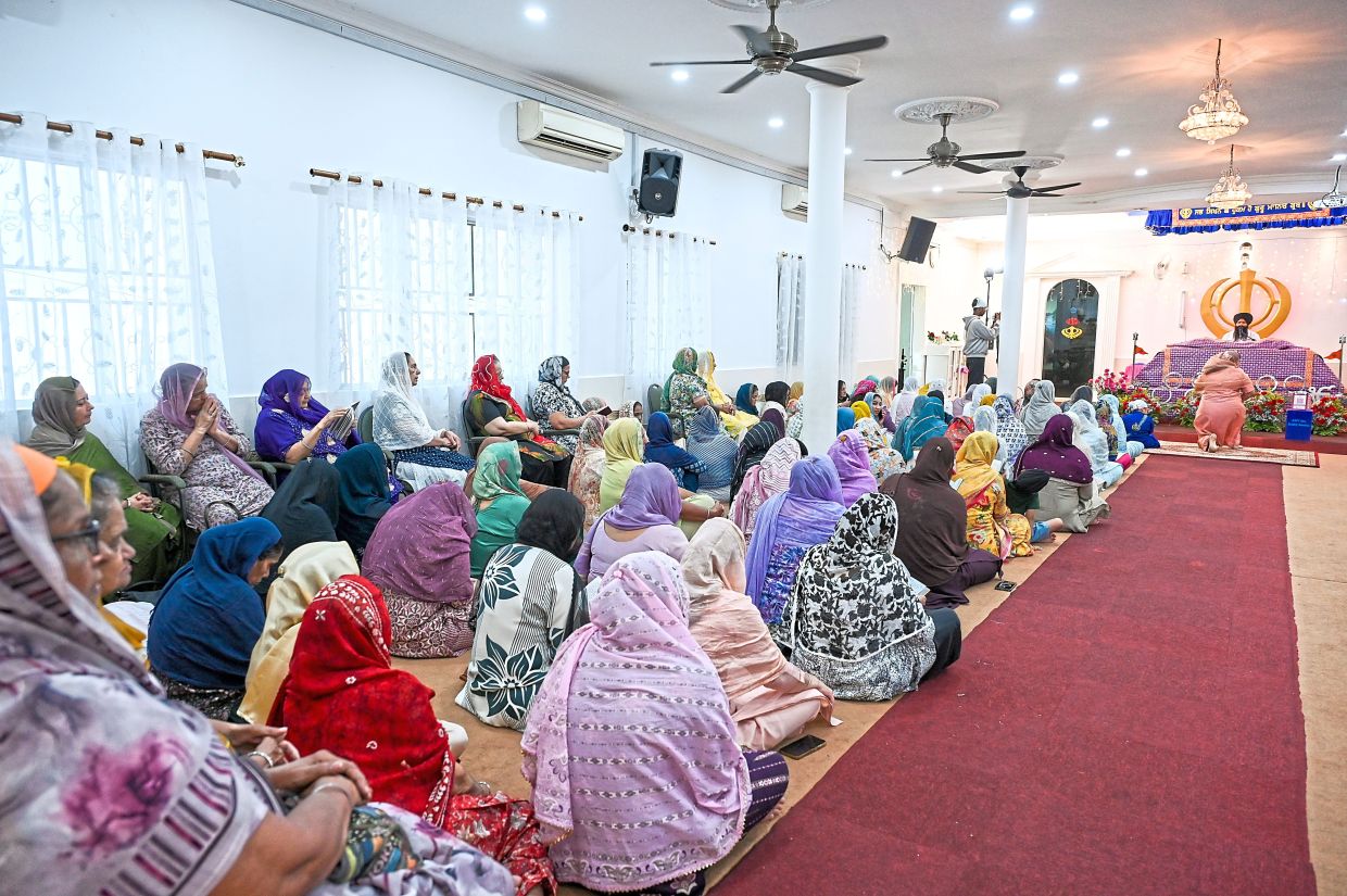 Devotees in the Darbar Sahib or prayer hall of the gurdwara on the last day. 