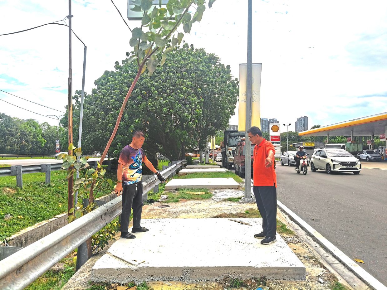 Yee (right) and Chung standing on the foundation of one of the 20 planned MyKiosk units in Kepong.