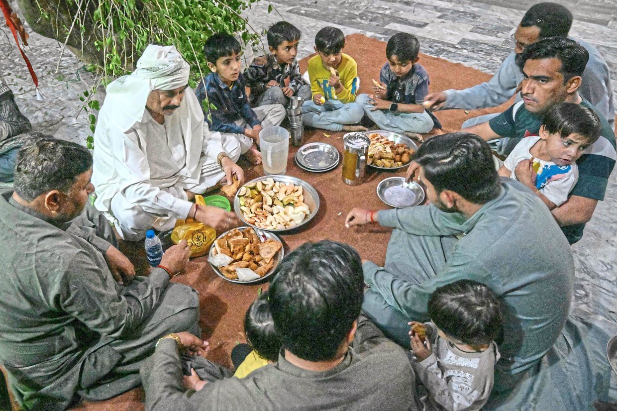 In south-east Pakistan, the holy month brings Hindus and Muslims closer as they experience fasting and iftar together in harmony. — AFP