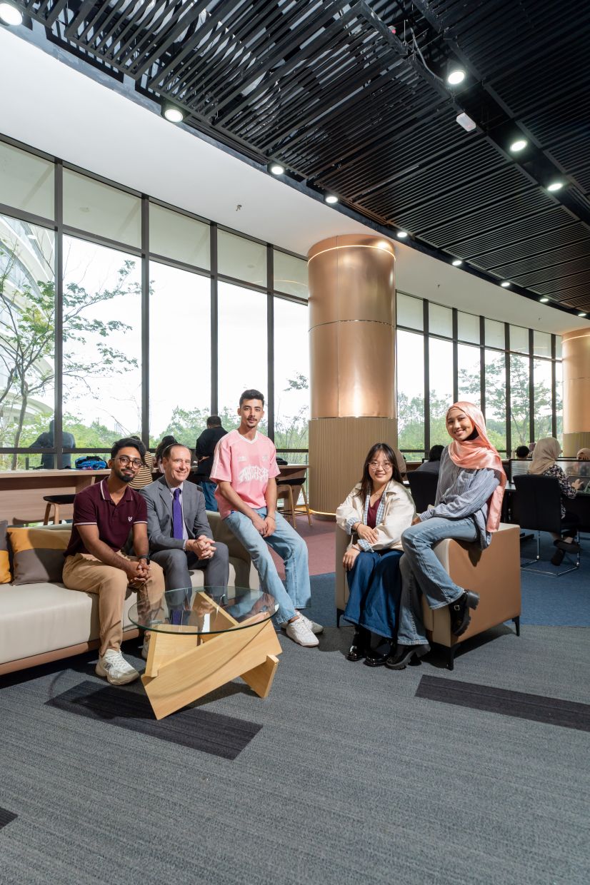 “The rankings clearly show the strength of our industry-relevant programmes and the quality of our academic environment,” said Prof Whitford, who is seated (centre) with UoC students.
