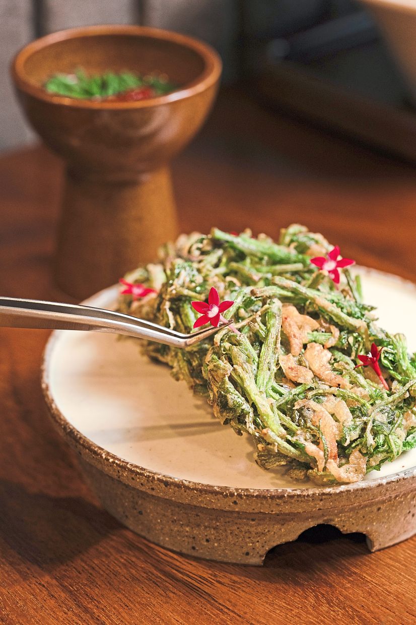 The minari pancakes are crisp little fried packets that highlight minari (water celery) in a lead role. — Modu