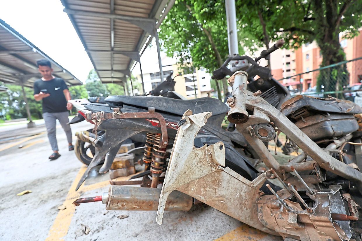A dismantled motorcycle at PPR Intan Baiduri occupying coveredparking space.