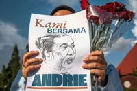 Police seek four suspects over acid attack on activist