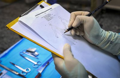 A forensic pathology team recording evidence during a post-mortem at Universiti Malaya Medical Centre\'s forensic department on 15 January,2026. — AZHAR MAHFOF/The Star