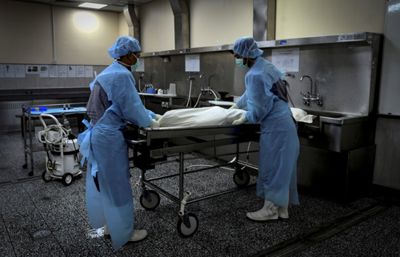 Forensics team preparing the dead body before a post-mortem at Universiti Malaya Medical Centre\'s forensic department on 15 January,2026. — AZHAR MAHFOF/The Star