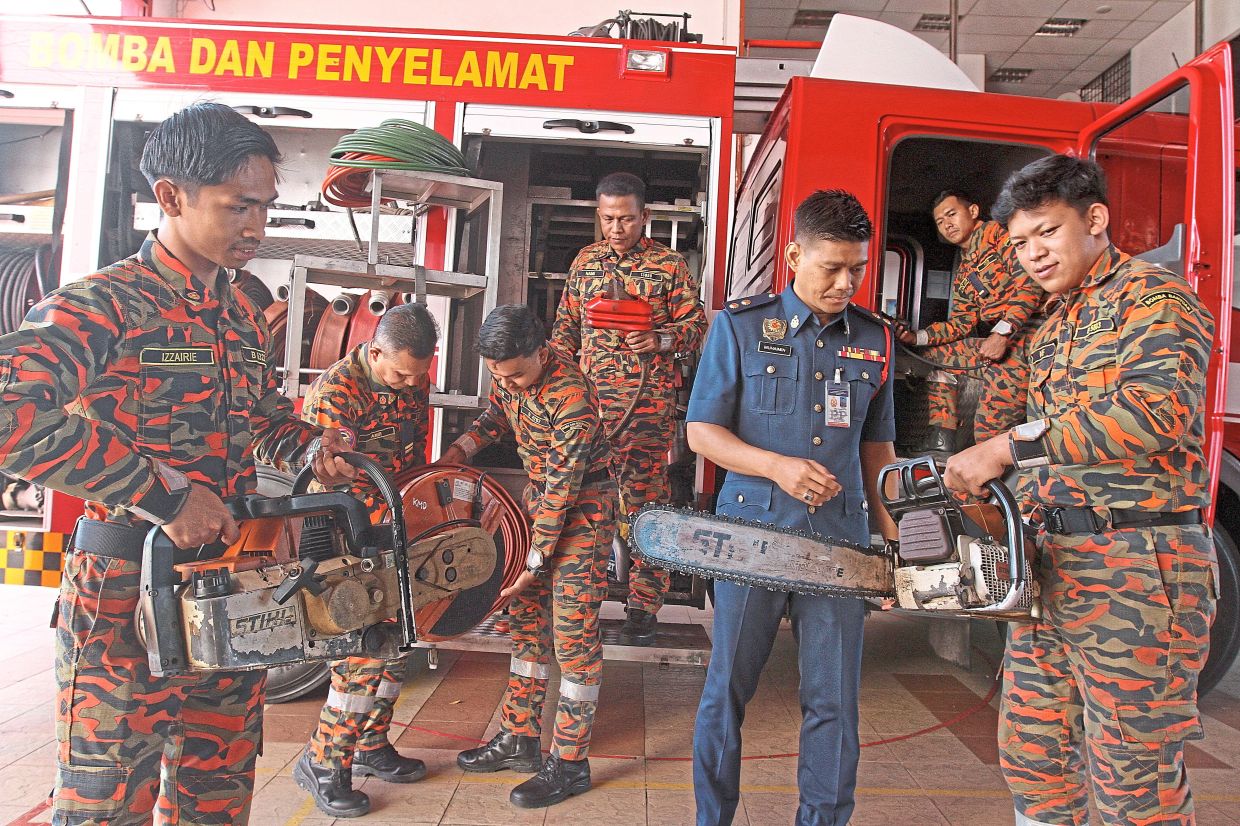 Kuala Muda Fire Station chief Ahmad Muhaimin (in blue) and his personnel making sure all the equipment is in good order for the holiday period.
