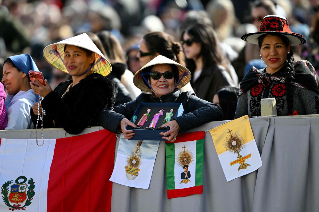 Faithful from Vietnam wait for Pope Leo XIV before the weekly general audience at St Peter's Square in the Vatican on Wednesday, March 18, 2026. -- Photo by Andreas SOLARO / AFP