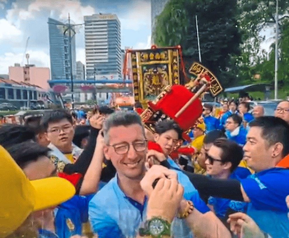 Frenchman Legave carrying a deity’s palanquin during the parade.
