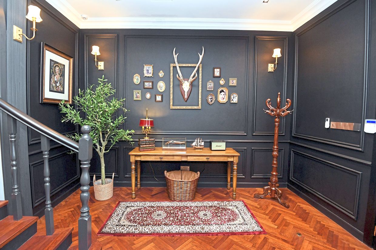 Family photos and heirlooms decorate the wall of the foyer.