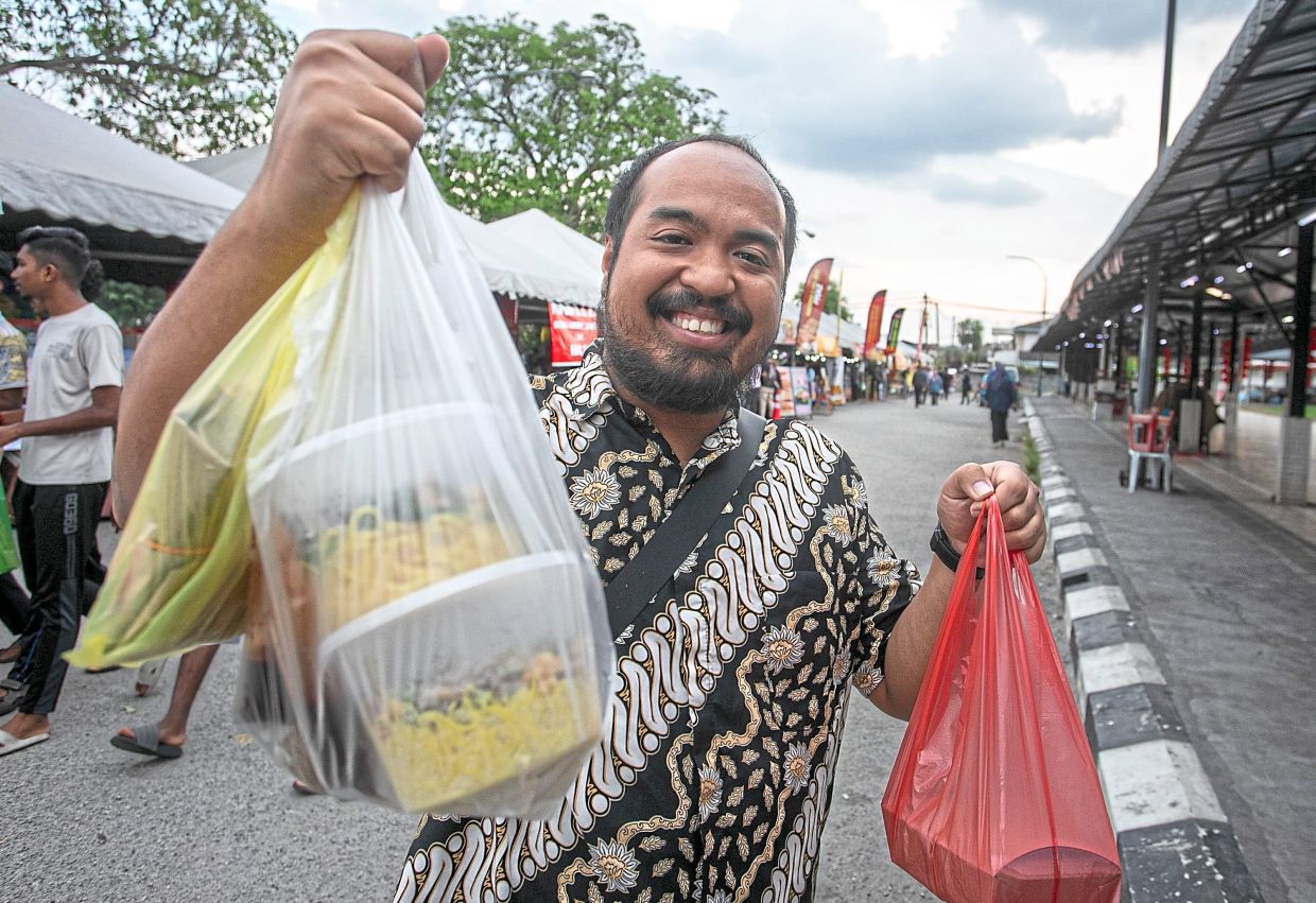 Zaire happy with his purchases from the BRR. — Photos: Bernama