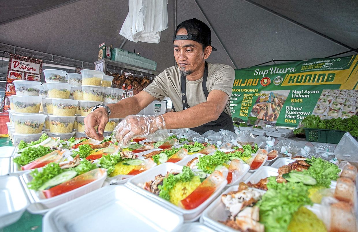Khamarul sells chicken rice and soup at his stall.