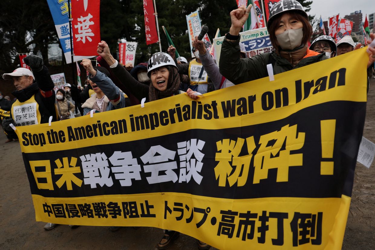 Protesters raising their fists and shouting slogans as they take part in an anti-US, anti-war and anti-Prime Minister Sanae Takaichi demonstration rally following a US-Japan summit meeting in Washington D.C. amid the US-Israeli conflict with Iran, in Tokyo on March 20, 2026.- Reuters