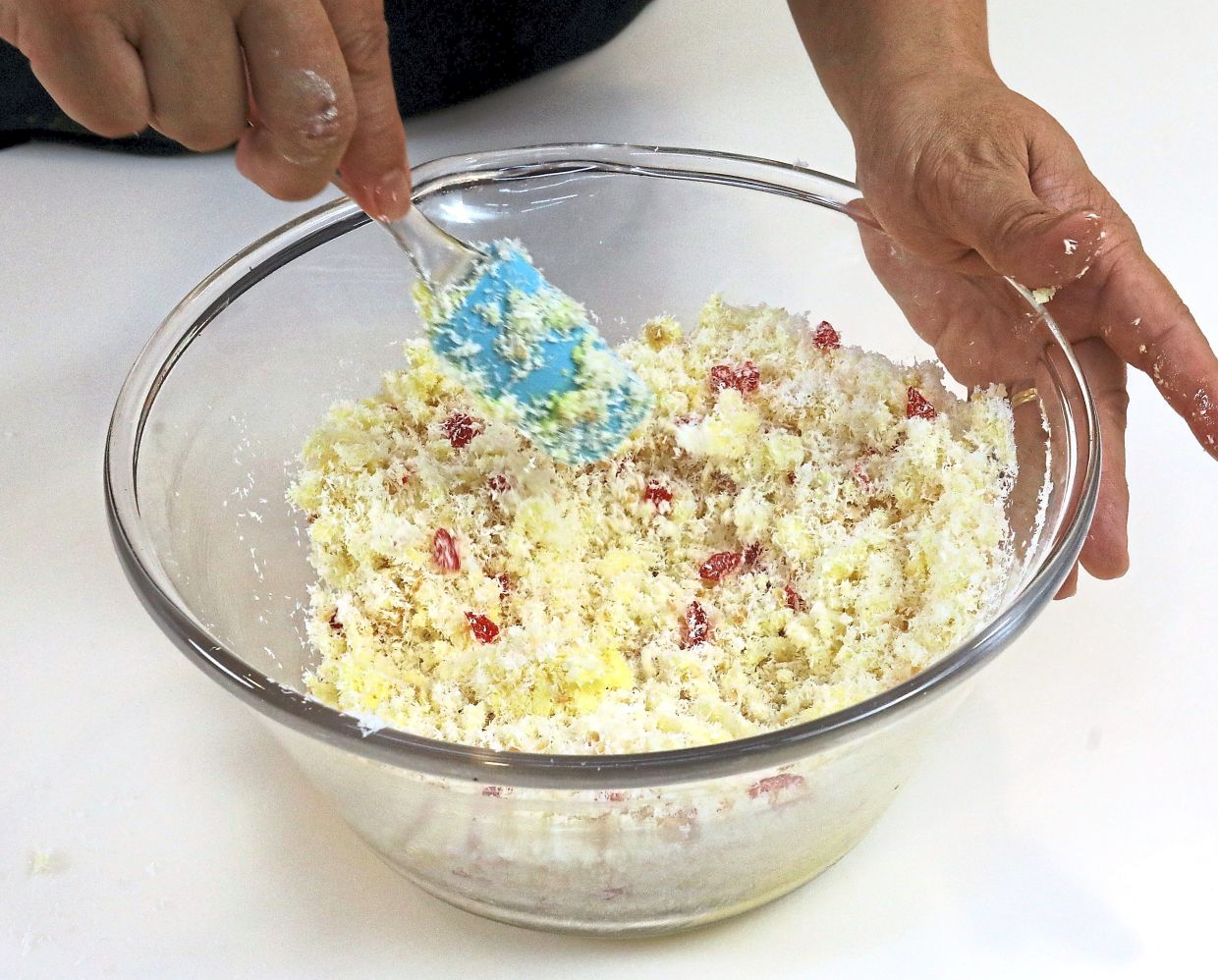 Cream the butter with the icing sugar until fluffy, then stir in desiccated coconut, salt, toasted almonds and cherries until evenly mixed.