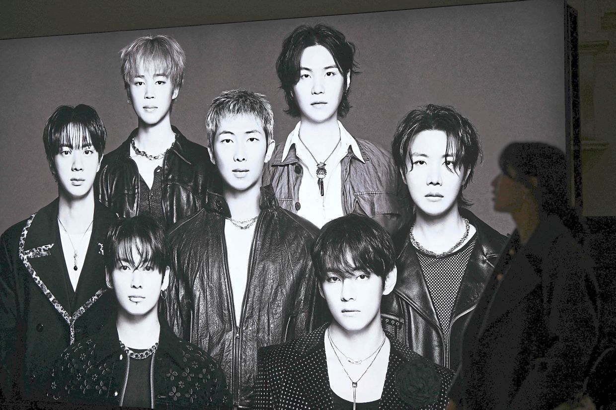 A visitor walking past a BTS poster at Shinsegae Department Store’s The Heritage in Seoul. — AP/AFP/Bloomberg