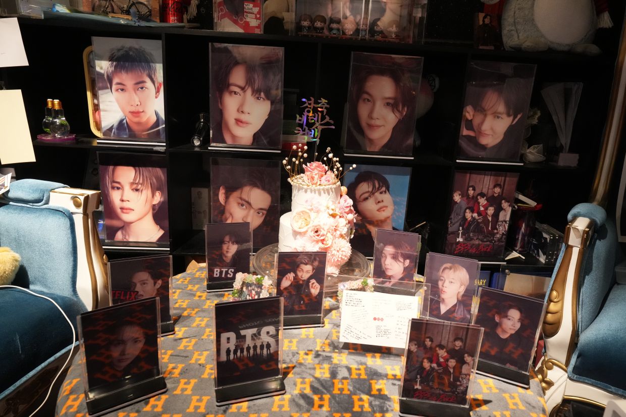 Photos of K-pop band BTS members displayed atthe cafe. - AP