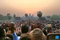 Huge crowds of tourists enjoy the equinox sunrise at Cambodia's iconic Angkor Wat