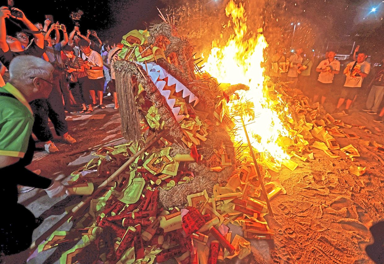 The fire dragon being set ablaze at the end of the procession.