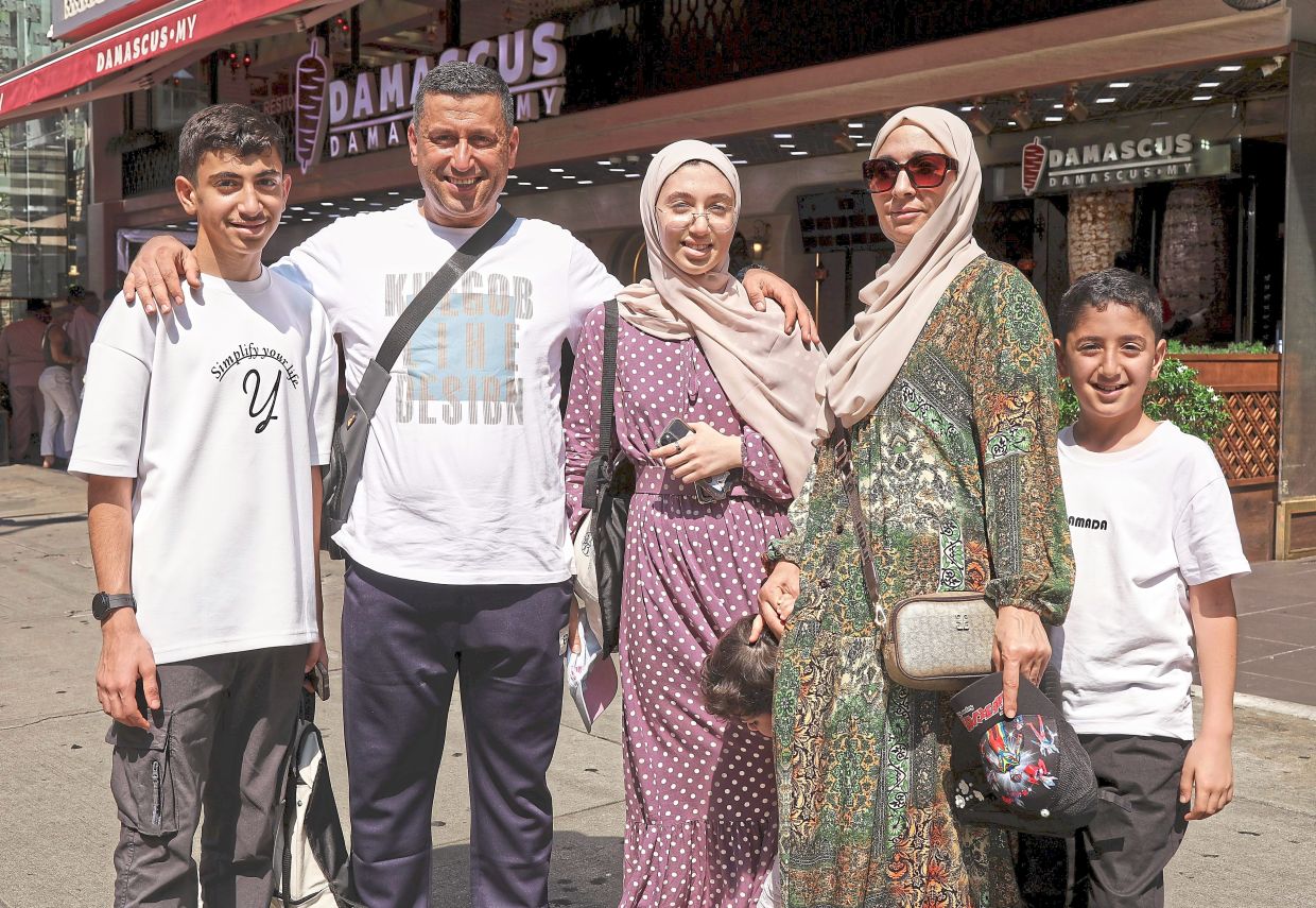 All smiles: Retal (centre) celebrating Hari Raya for the first time in Malaysia with her family. — YAP CHEE HONG/The Star
