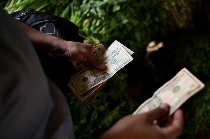 Dollar scarcity in Venezuela forces small firms to raise prices, turn to crypto