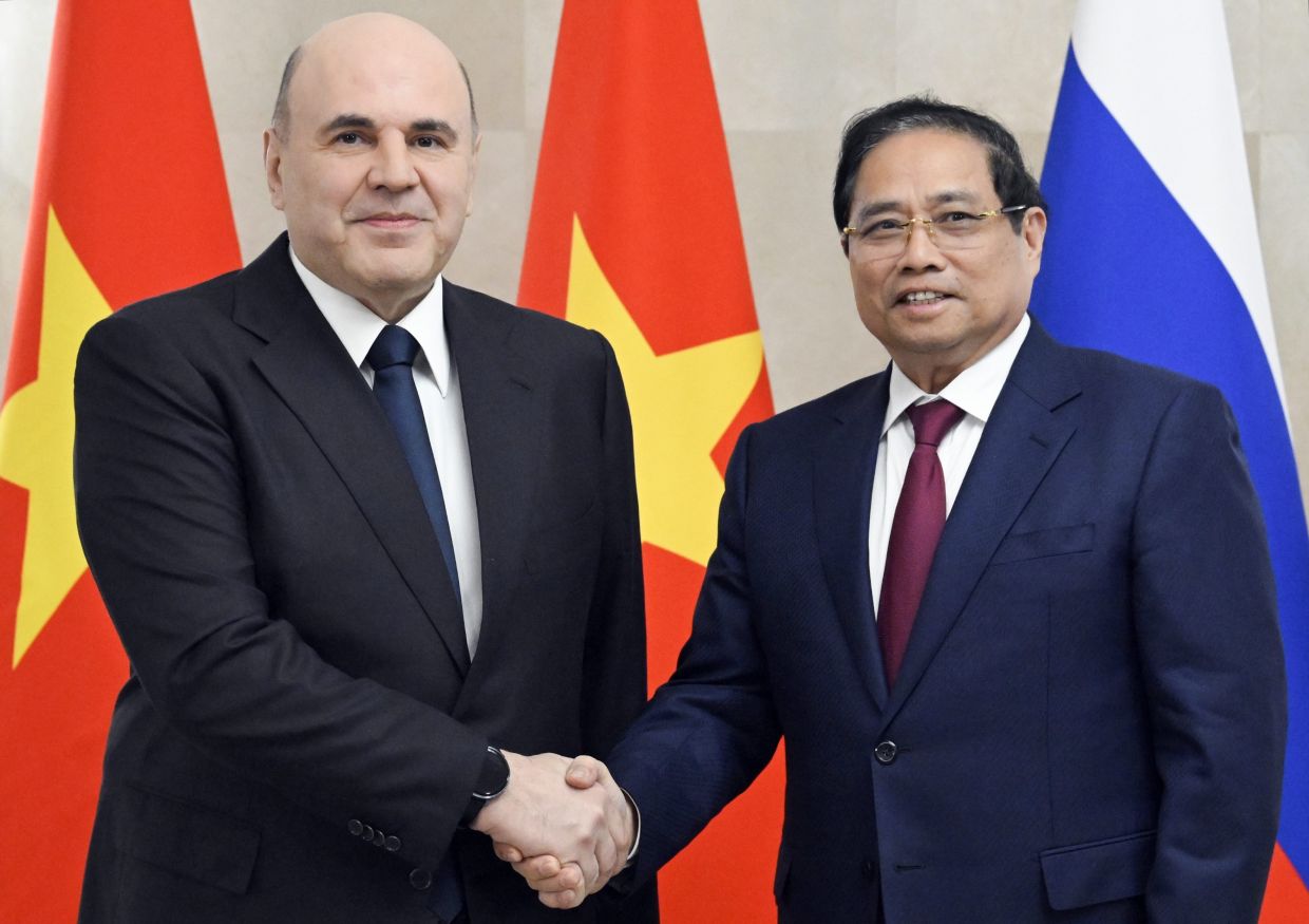 Russian Prime Minister Mikhail Mishustin, left, and Vietnamese Prime Minister Pham Minh Chinh pose during their meeting in Moscow, on Monday, March 23, 2026. -- Alexander Miridonov, Sputnik, Government Pool Photo via AP