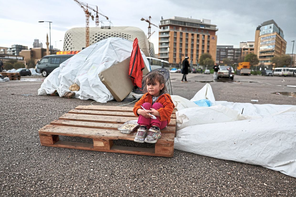 5. A girl sitting on a pallet in a temporary encampment for displaced people during Aidilfitri celebrations in Beirut, Lebanon. — Reuters