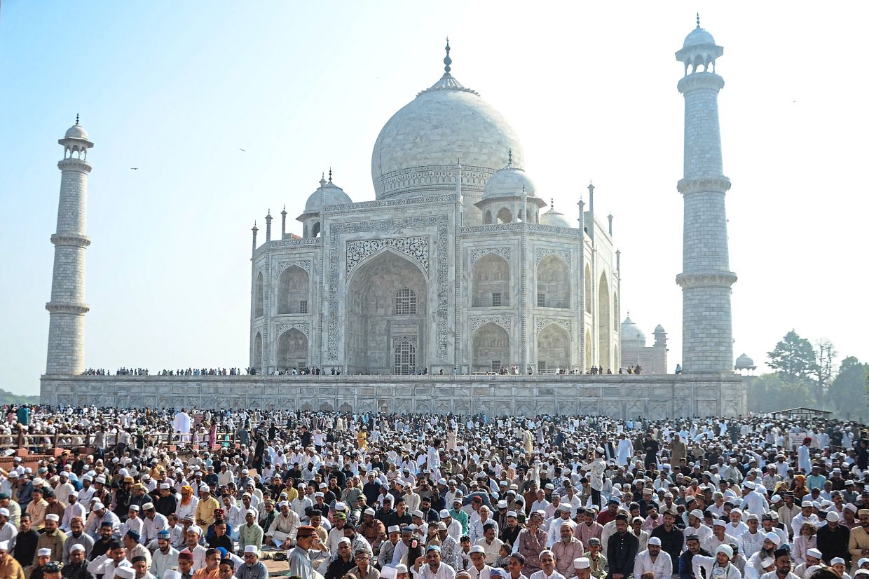 4. Worshippers gathering for prayers near the Taj Mahal in Agra, India. — AFP