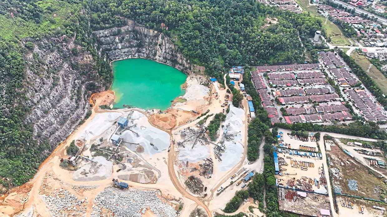 A drone shot showing how close the quarry area in Bukit Lagong Forest Reserve (left) is to Taman Matang Jaya houses (right) in Sungai Buloh. —Photos: GRACE CHEN, YAP CHEE HONG and LEONG WAI YEE/The Star