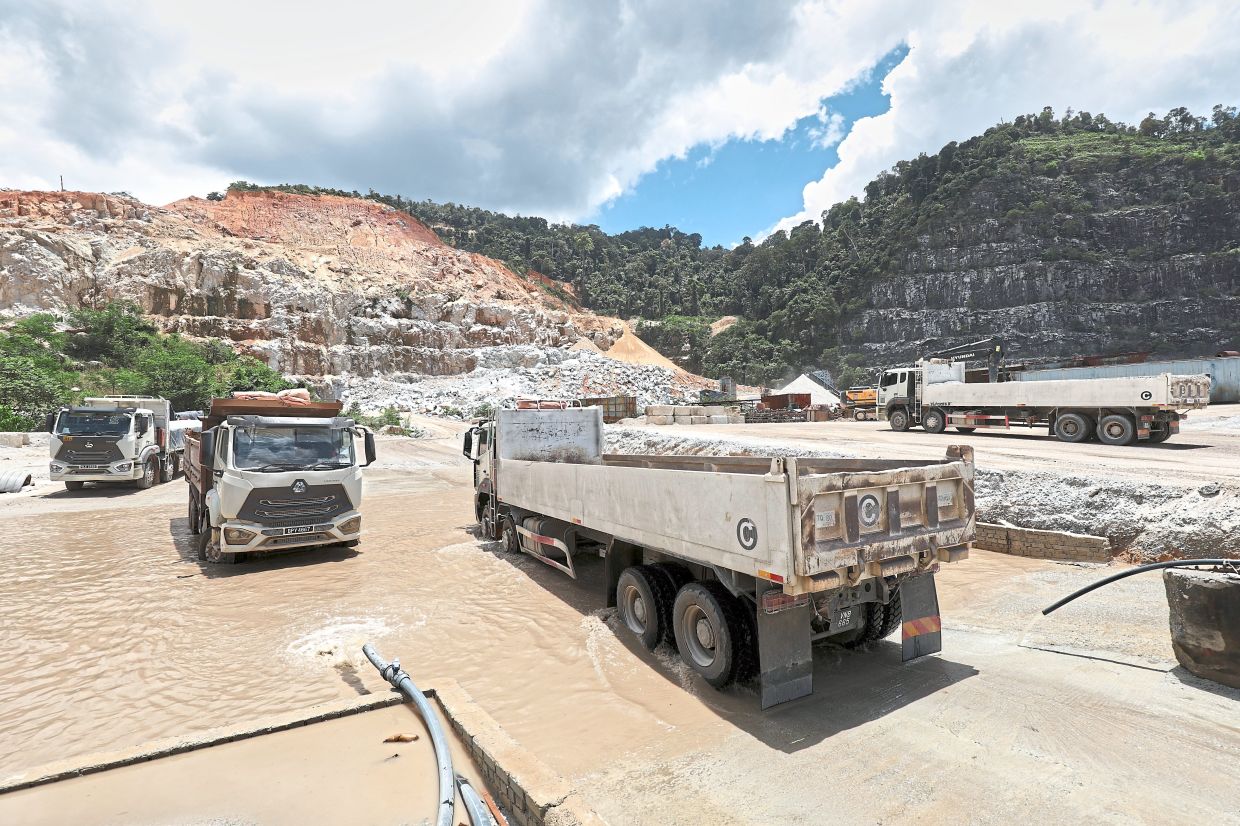 The common vehicle washing bay at one of the junctions leading from the five quarries operating at Bukit Lagong Forest Reserve into the public road.
