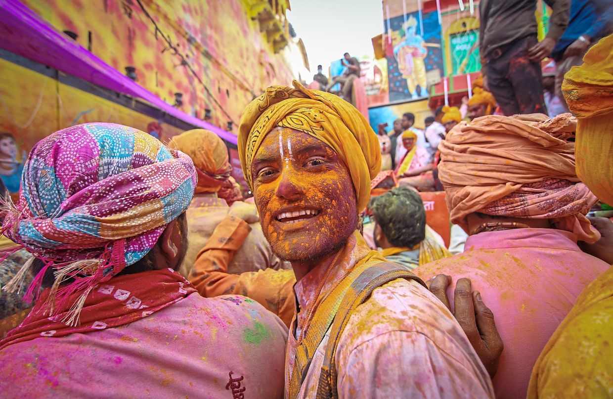9. A man covered in colours taking part in Lathmar Holi celebrations in Barsana, Uttar Pradesh. — Reuters