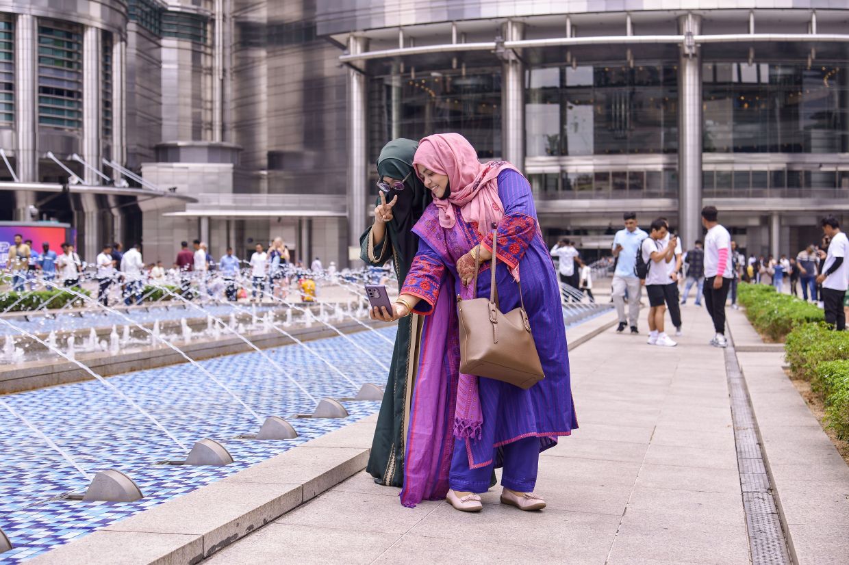 4. Foreign visitors seizing the opportunity to capture memories with loved ones around the Petronas Twi Towers, as the iconic landmark draws crowds who remain in Malaysia over the Hari Raya Aidilfitri holidays. — Bernama