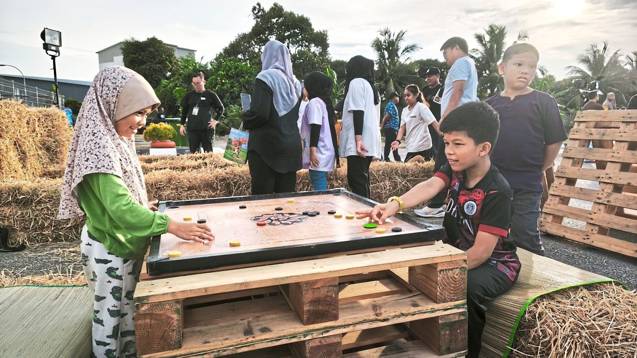Children enjoying a game of carrom at KBF.