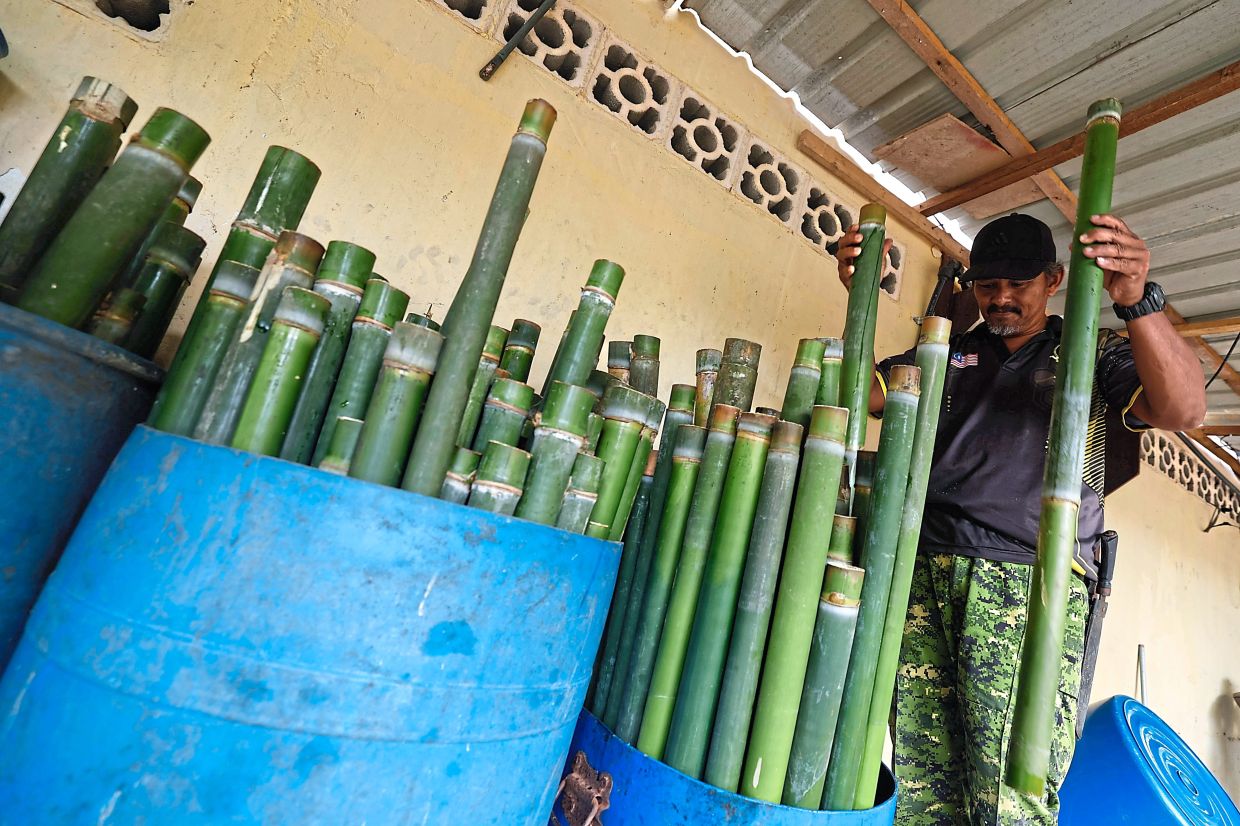 Mohd Alias storing the bamboo in his home.