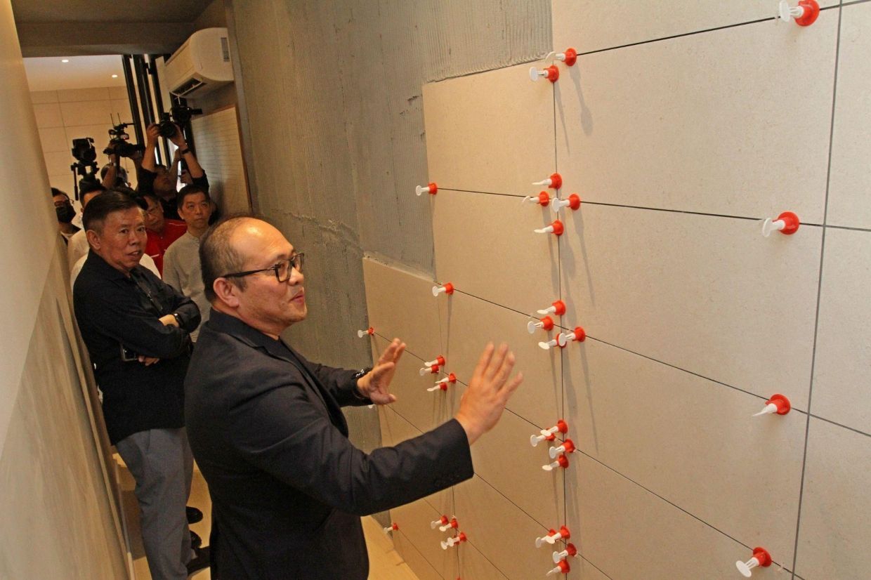 Lee Chee Seng (front) taking media guests through the Satellite Quality Centre at the new SkyWorld Gallery @ Seberang Jaya.