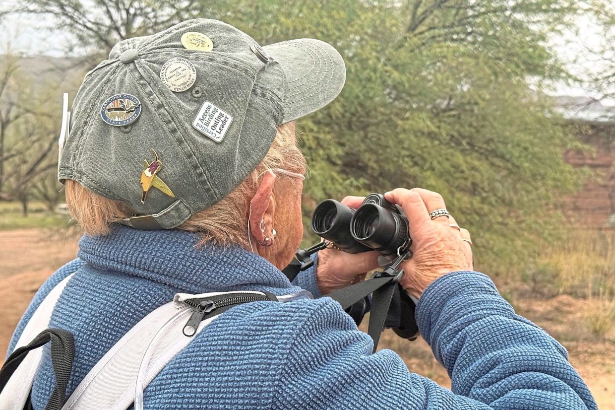 OBara checks the landscape for birds during an accessible birding walk. — Photos: Anita Snow via AP