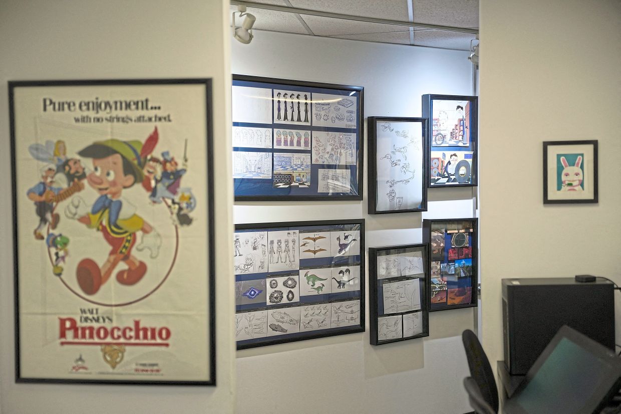 Drawings and sketches fill the walls of a hallway at the studio. 