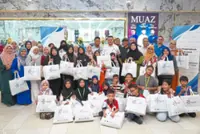 Waste management firm takes poor families Raya shopping
