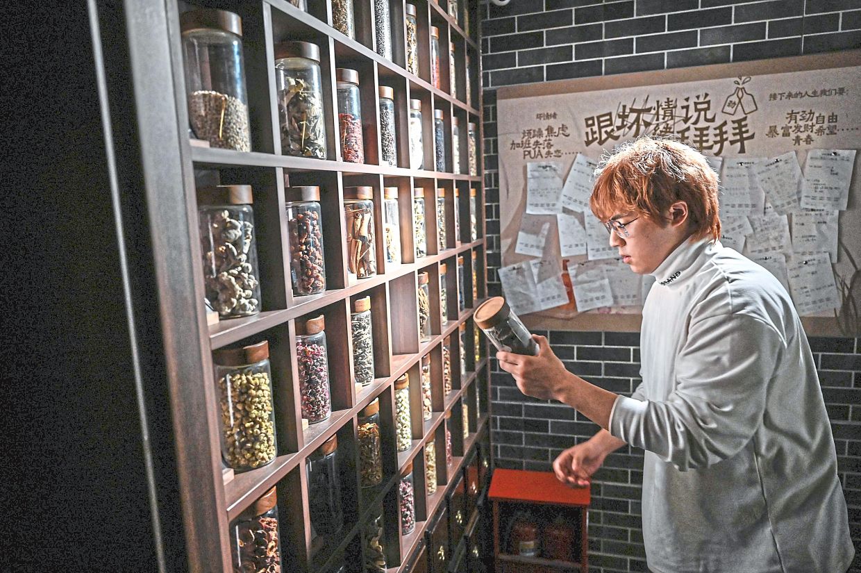 Wu checking traditional herbal ingredients at his bar Niang Qing in Shanghai. The bar has expanded to five locations nationwide in just one year. — AFP
