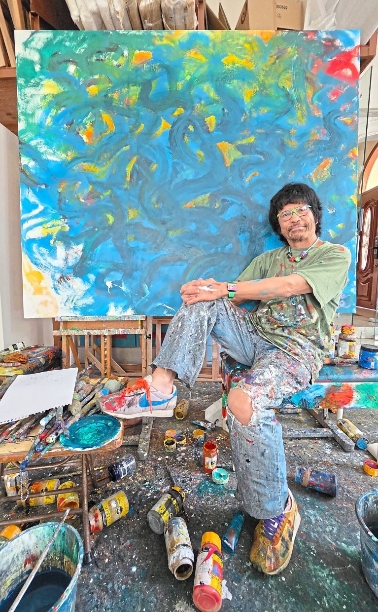 The artist with ‘Holiday at Pulau Redang’, one of his new works.