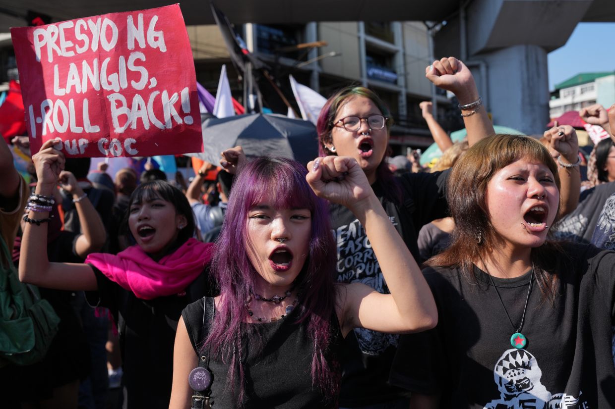 Participants shout slogans during a rally by transport workers and activists protesting the rise in oil prices on Friday, March 27, 2026, near the Malacanang presidential palace in Manila, Philippines. -- AP Photo/Aaron Favila