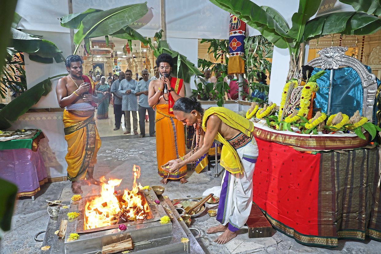 Temple priests and devotees taking part in the yagam during the Ugadi celebrations at Sri Ramar Temple, Solok York, George Town, Penang. —CHAN BOON KAI/The Star