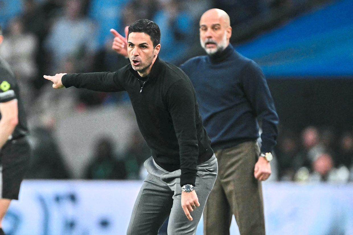 Guardiola (right) and Arteta could yet figure in an absorbing showdown for the league title. — Photos: AFP